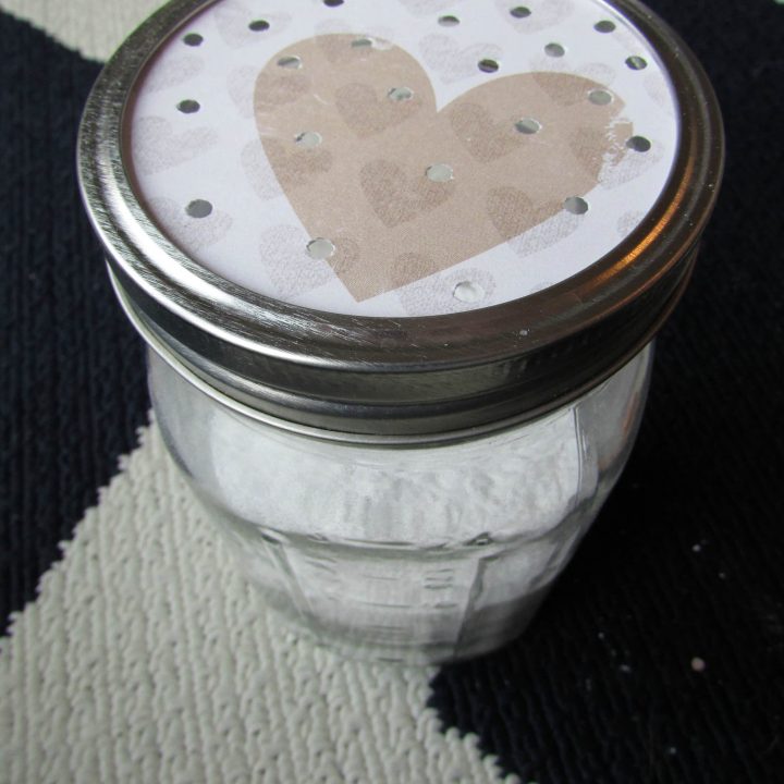 glass mason jar filled with white powder and shaker top
