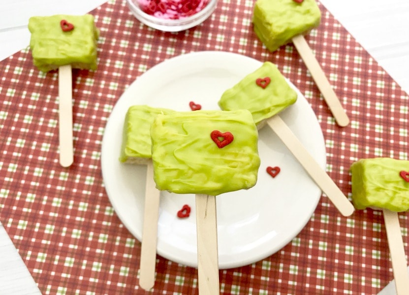 These Grinch Christmas Rice Krispies Treats are a fun and easy treat to make with your kids! This easy recipe is perfect for your next holiday party or making holiday memories watching a favorite Christmas movie with a special treat!