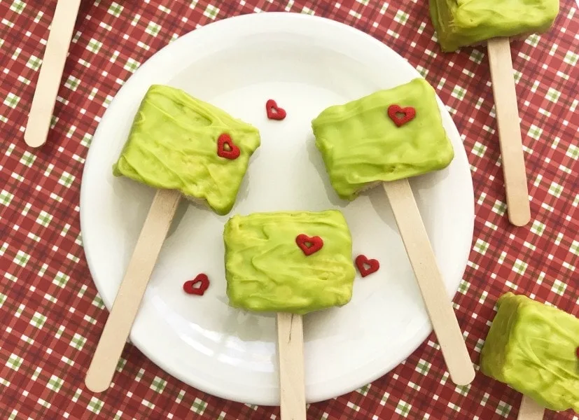 These Grinch Christmas Rice Krispies Treats are a fun and easy treat to make with your kids! This easy recipe is perfect for your next holiday party or making holiday memories watching a favorite Christmas movie with a special treat!