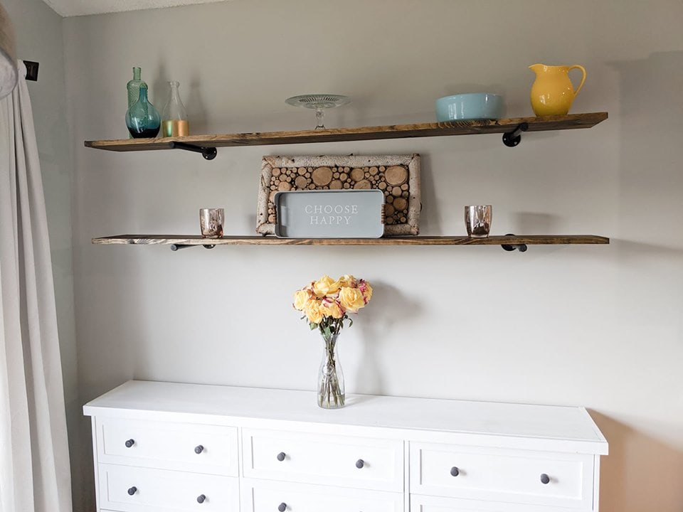 easy DIY pipe shelves above a white credenza