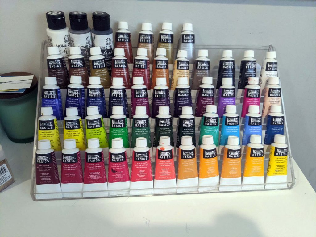 display case with a rainbow of paint colors