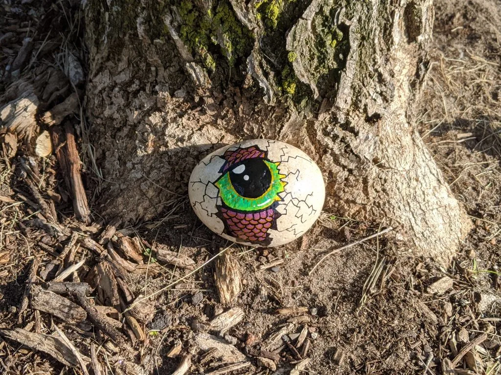 rock painted to resemble a dragon hatching